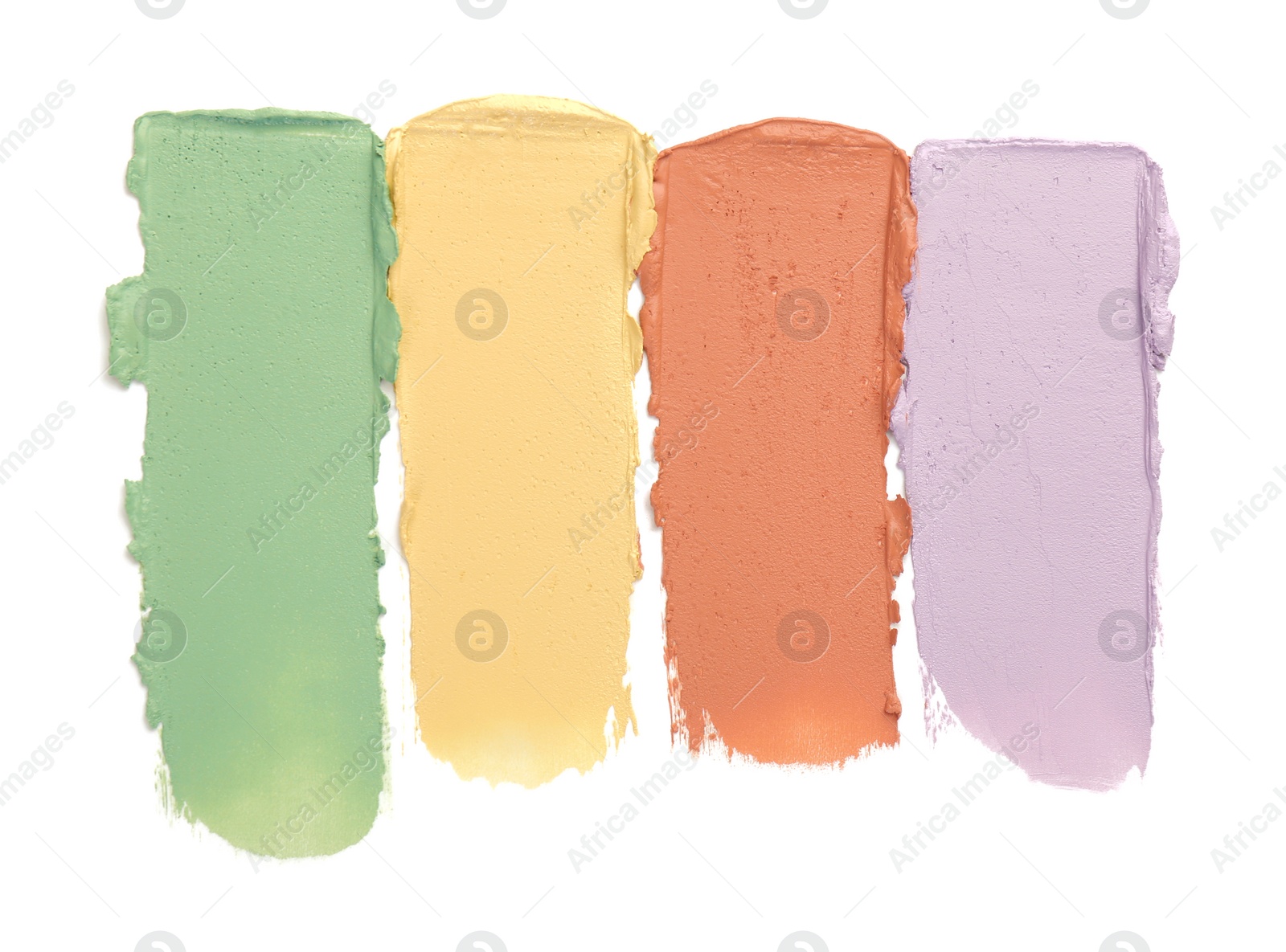 Photo of Samples of color correcting concealers isolated on white, top view