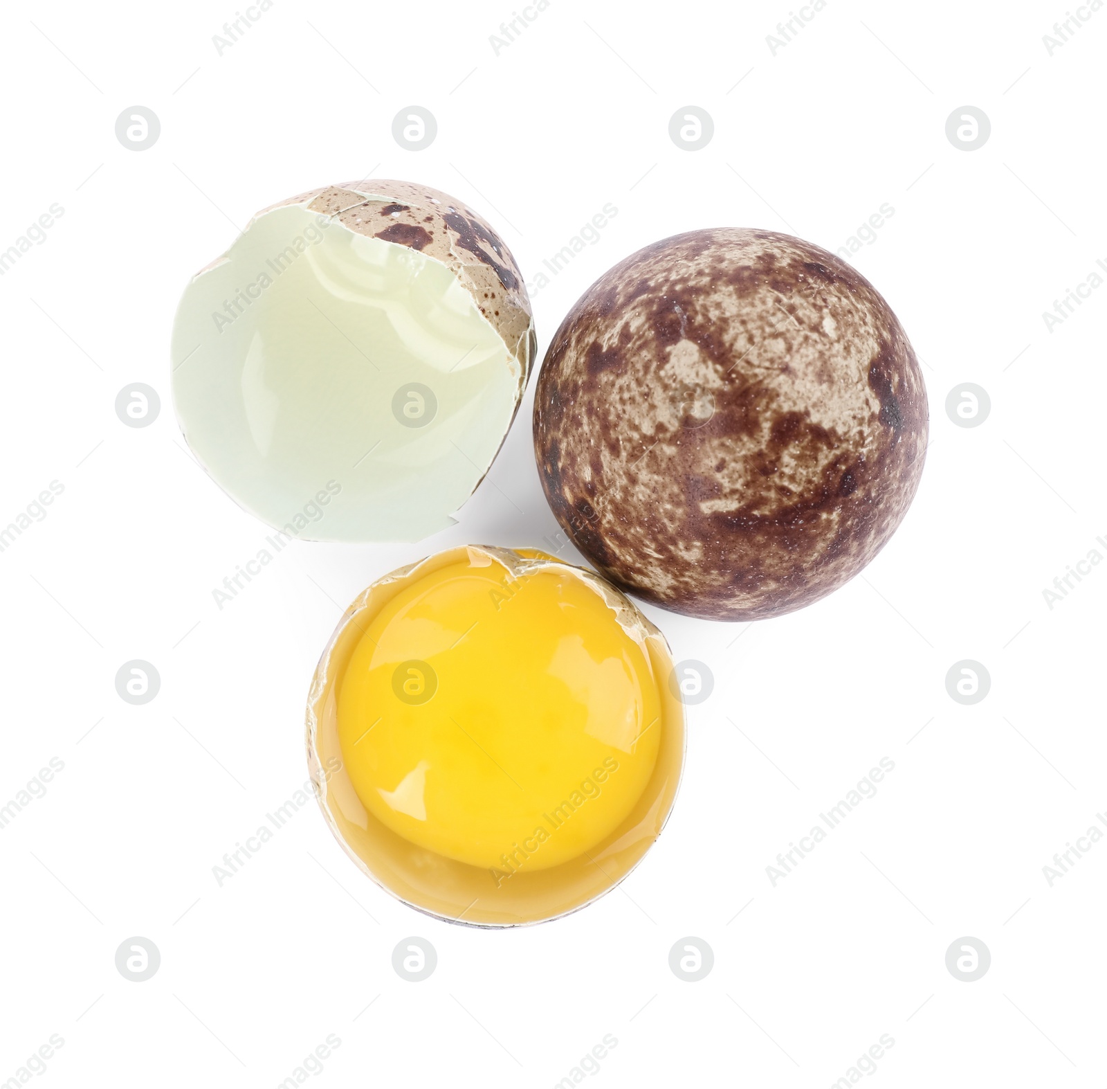 Photo of Whole and cracked quail eggs on white background, top view