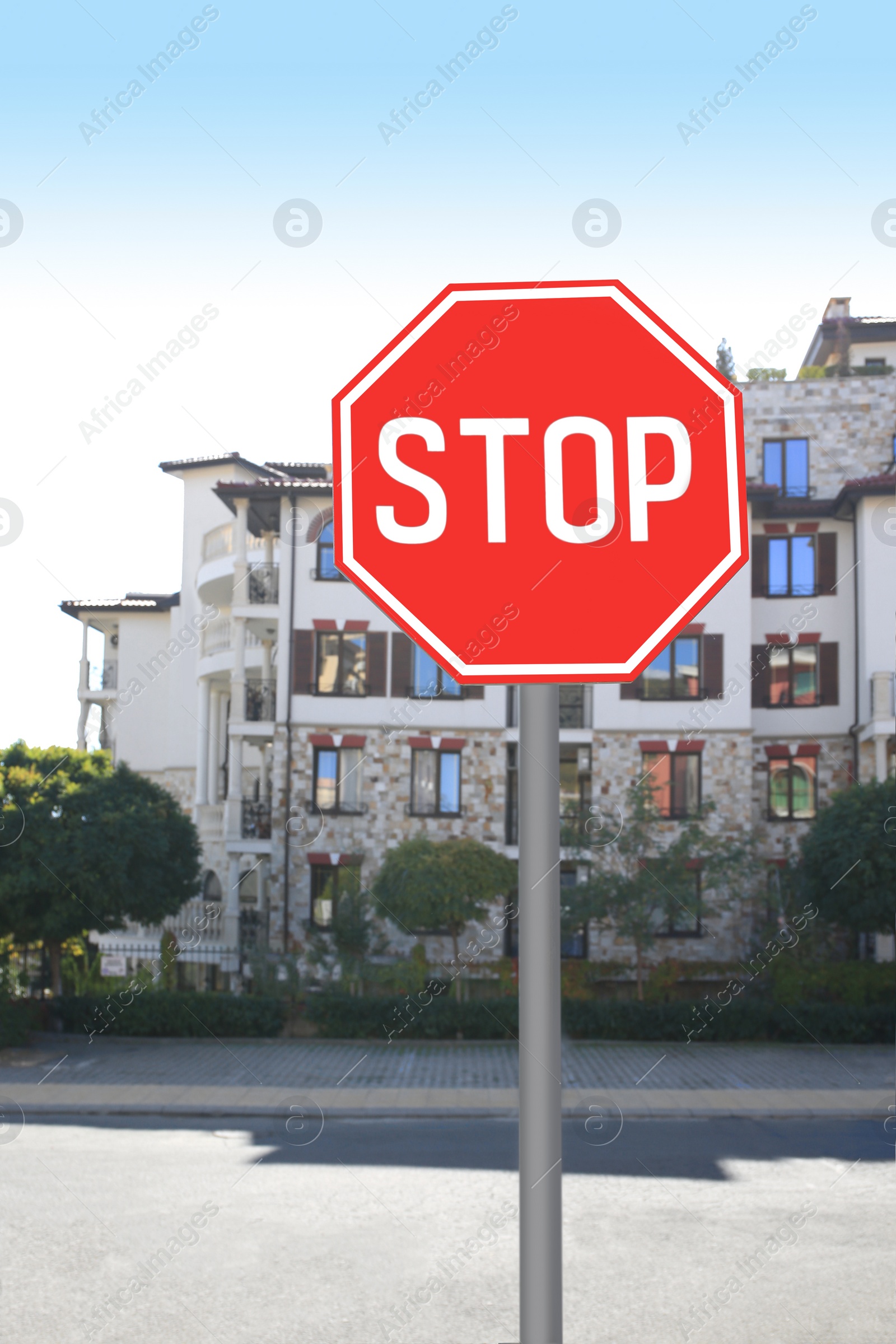 Photo of Post with Stop sign on city street