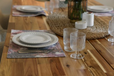 Beautiful table setting. Plates, cutlery, glasses and napkin