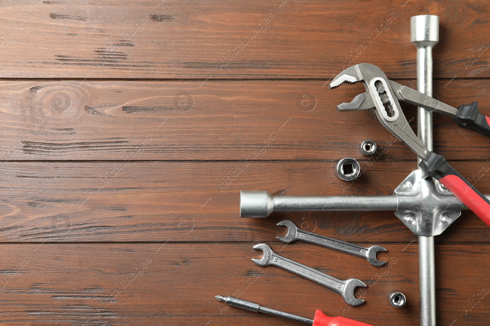 Photo of Auto mechanic's tools on wooden background, flat lay. Space for text