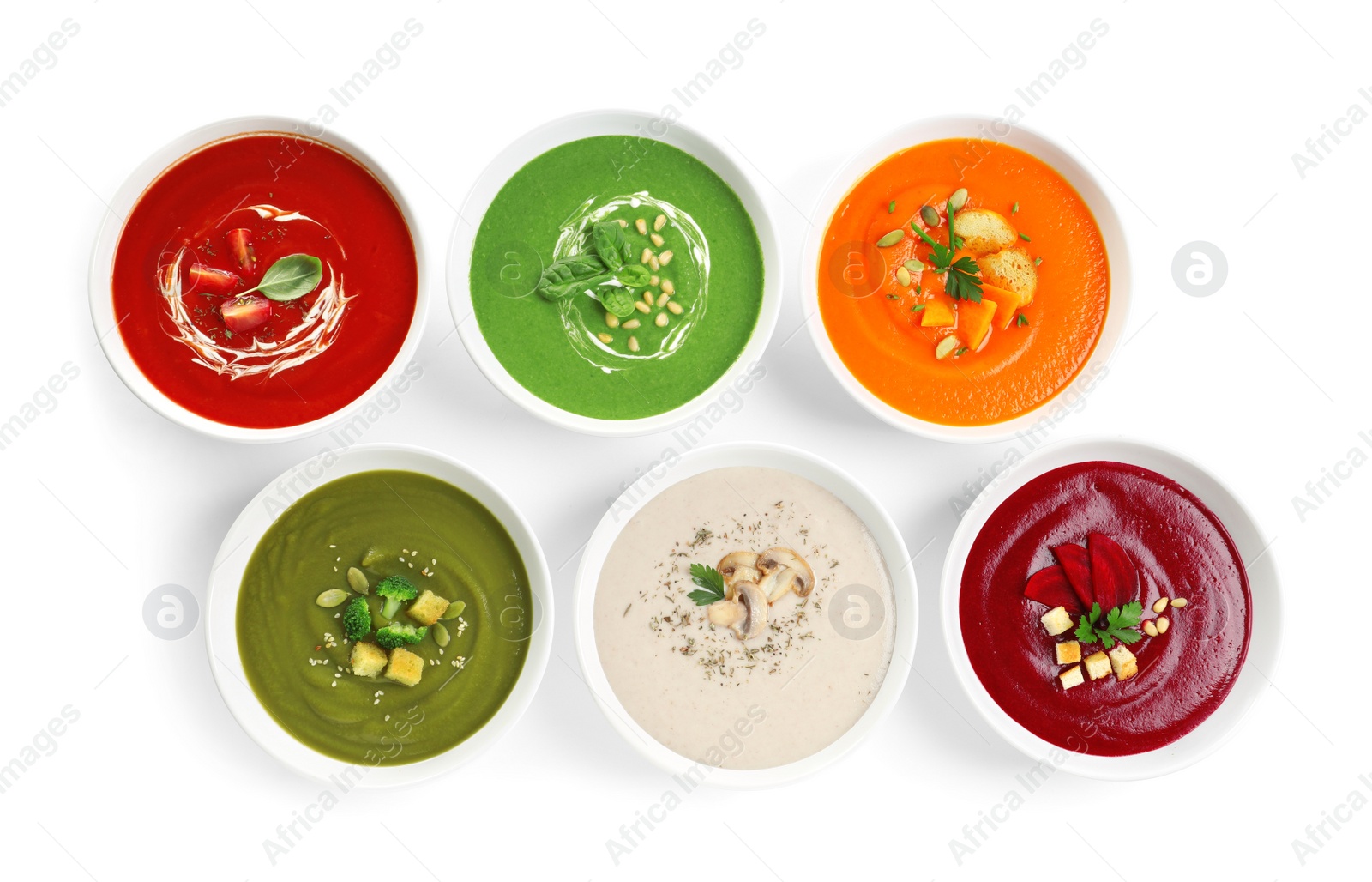 Photo of Various soups in bowls on white background, top view. Healthy food