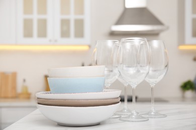 Set of clean dishes on table in stylish kitchen