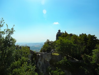 Photo of Picturesque view of castle near trees on sunny day