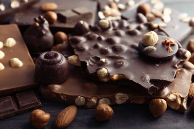 Photo of Different delicious chocolate bars and candies, closeup