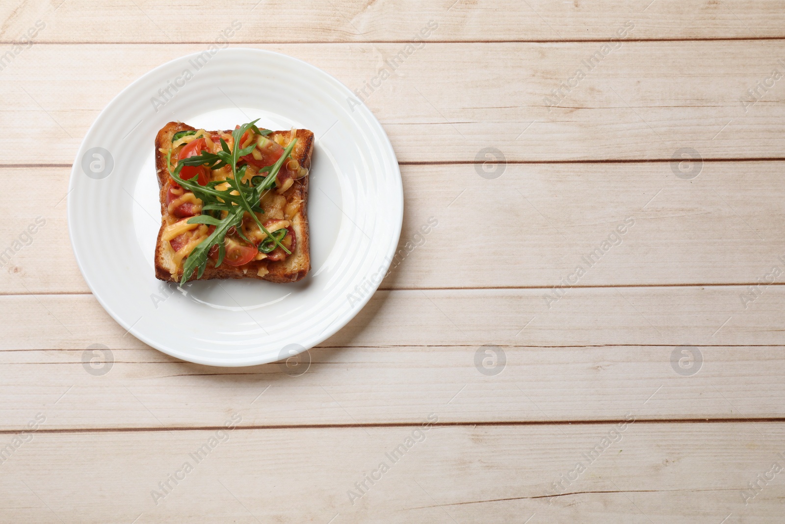 Photo of Tasty pizza toast on light wooden table, top view. Space for text