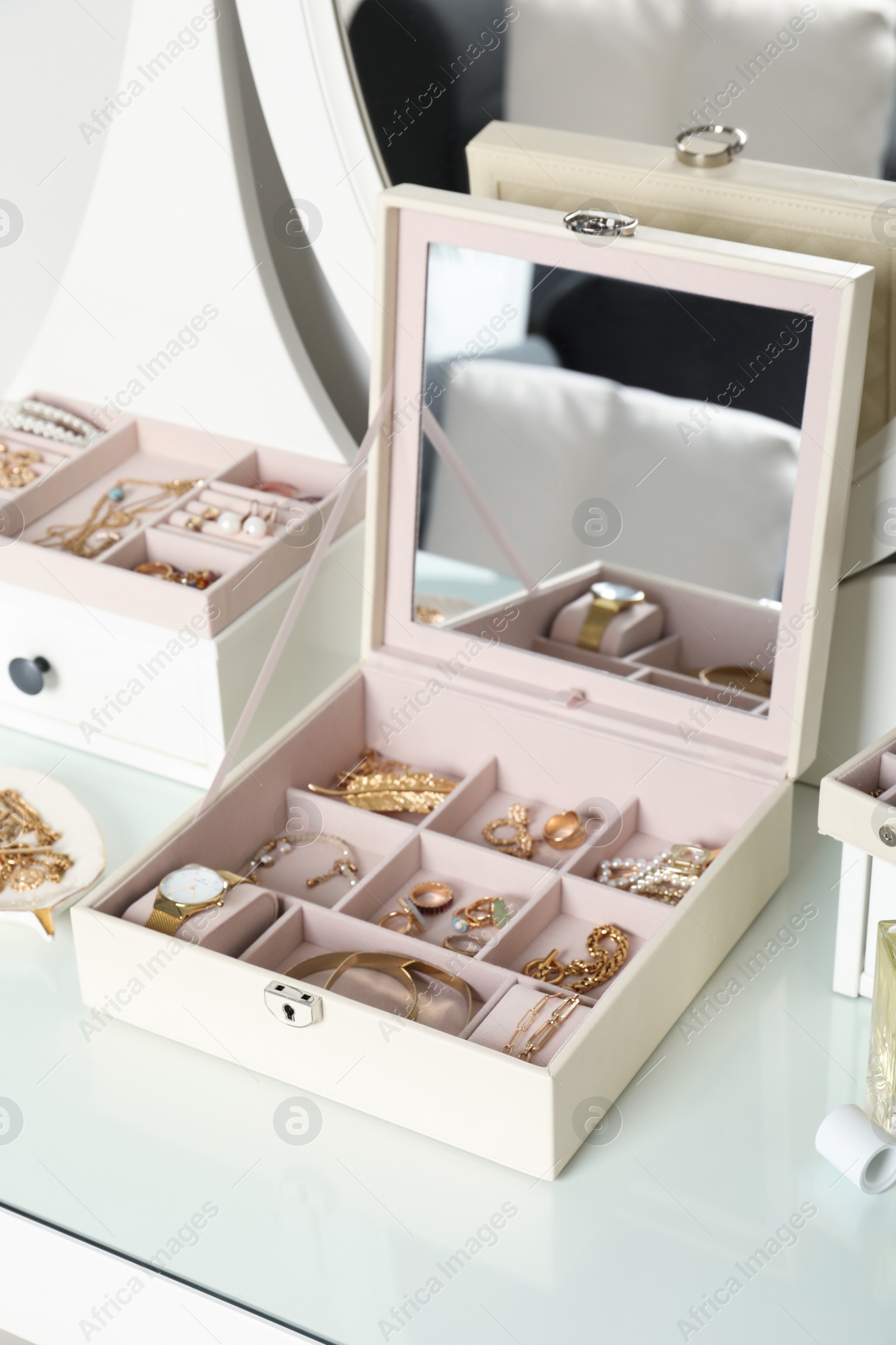 Photo of Elegant jewelry box with beautiful bijouterie on dressing table