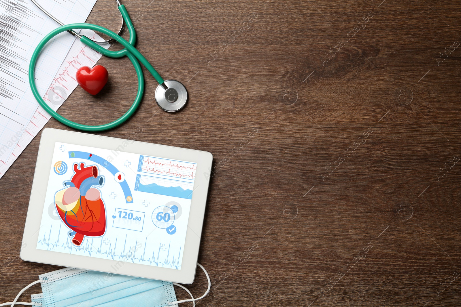 Photo of Flat lay composition with tablet and red heart on wooden table, space for text. Cardiology concept