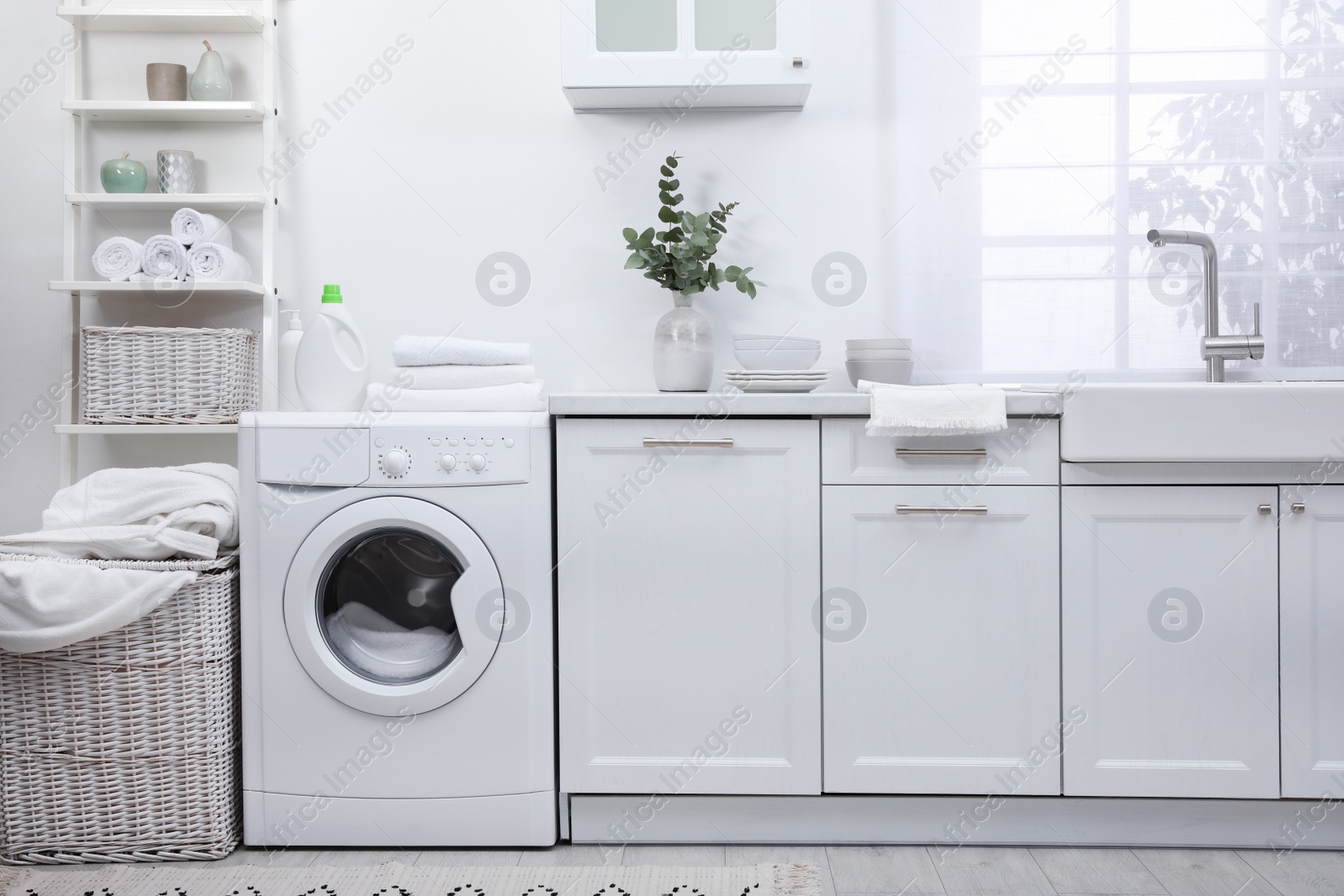 Photo of Kitchen interior with washing machine and stylish furniture