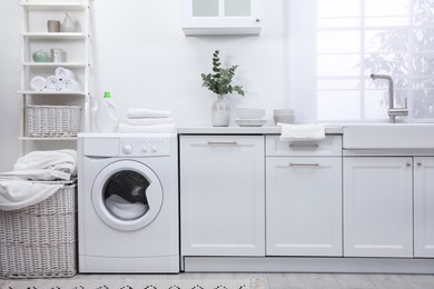 Kitchen interior with washing machine and stylish furniture