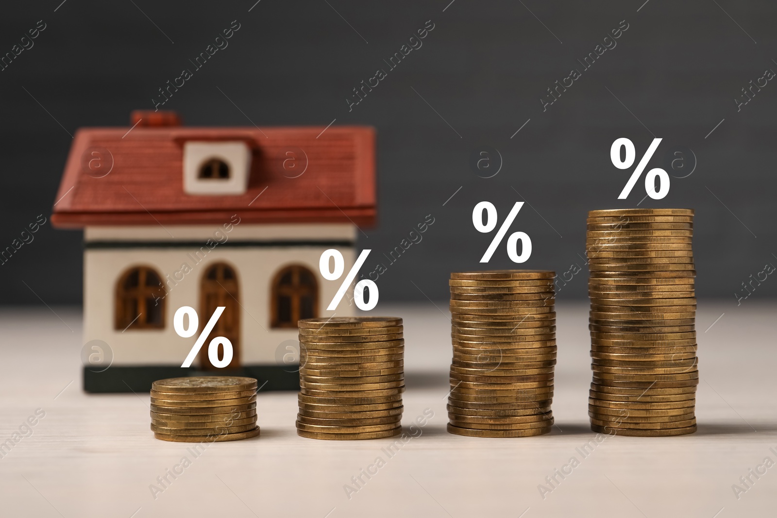 Image of Mortgage rate. Stacked coins, percent signs and model of house