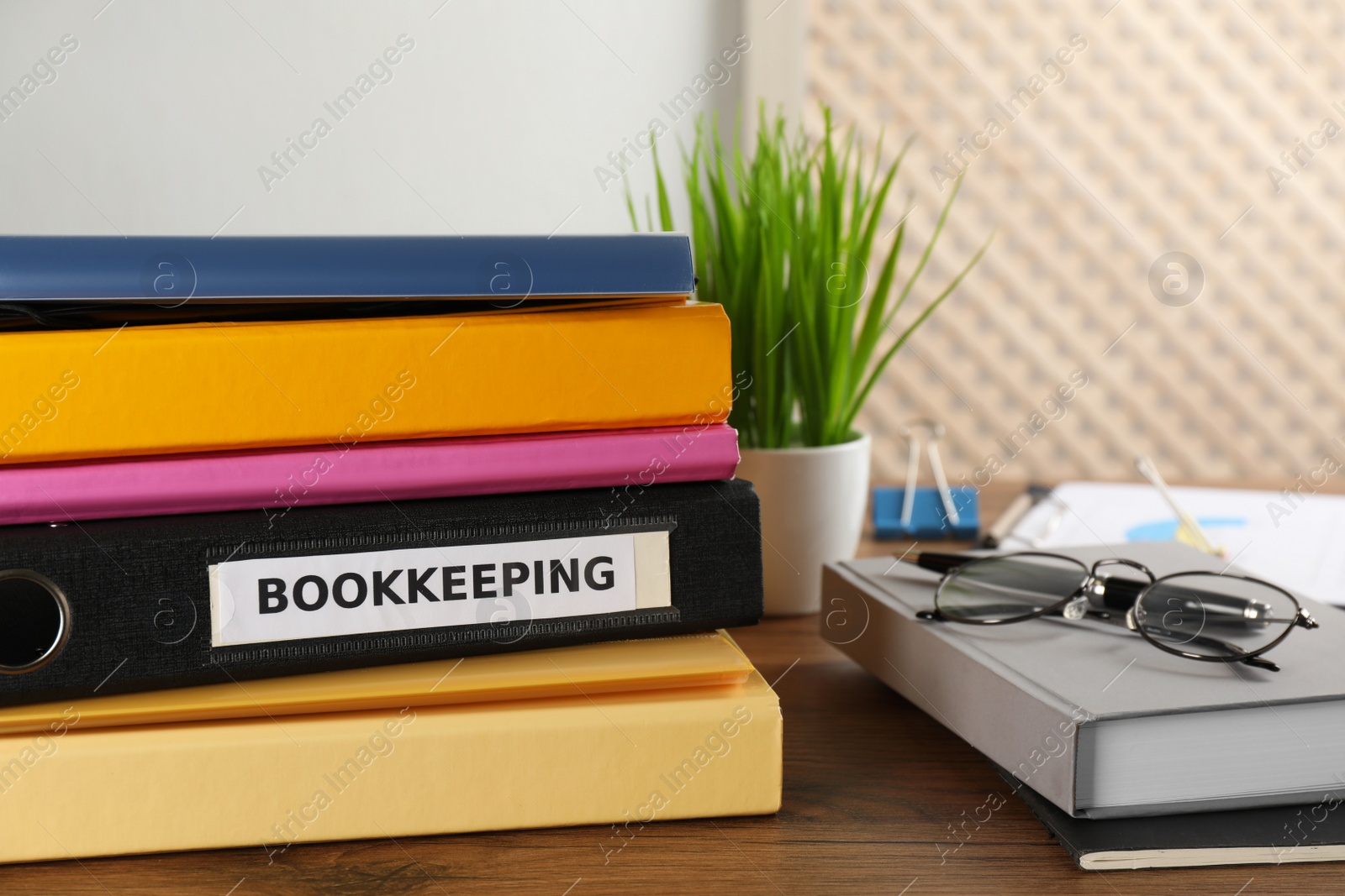 Photo of Folders and stationery on desk in office. Bookkeeper's workplace