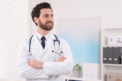 Medical consultant with stethoscope in clinic, space for text