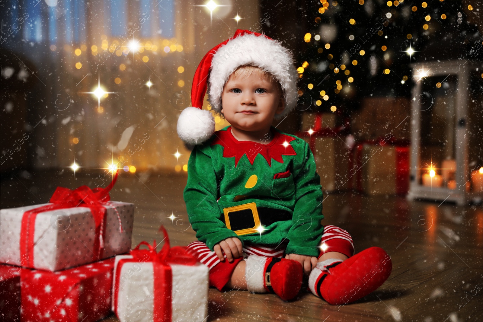 Image of Baby wearing cute Christmas costume with gifts at home