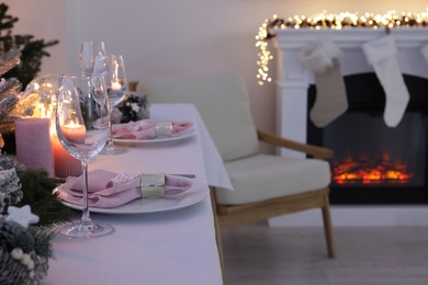 Beautiful festive table setting with Christmas decor in room, space for text