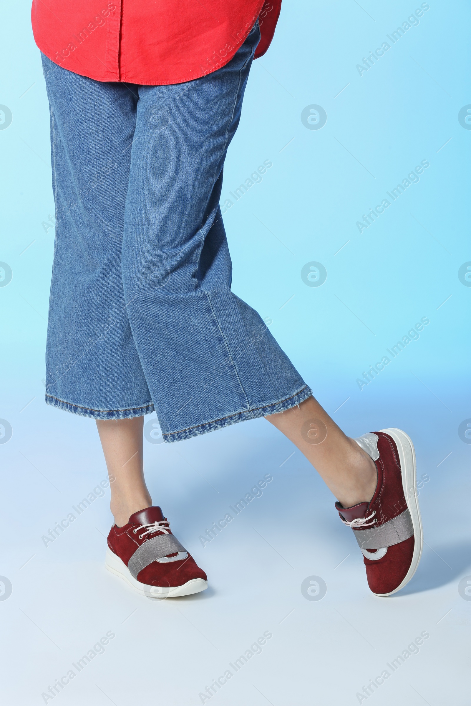 Photo of Woman in stylish shoes on color background, closeup