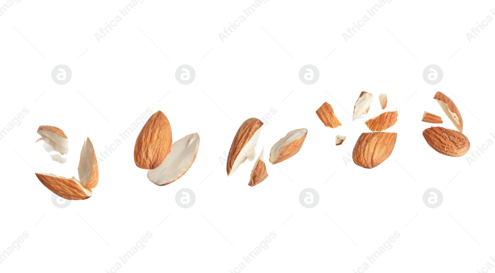 Photo of Pieces of tasty almonds on white background