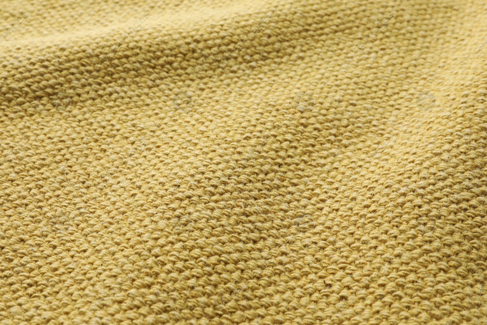 Photo of Texture of golden color fabric as background, closeup