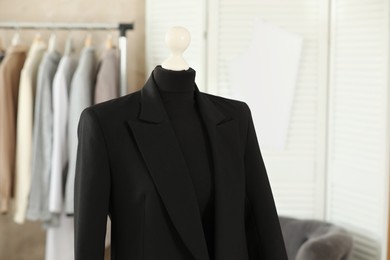 Photo of Mannequin with black jacket in tailor shop