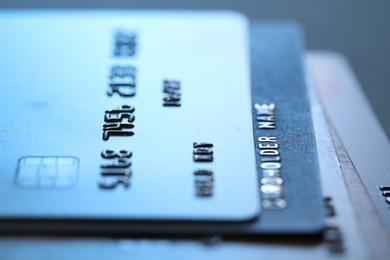 Photo of Many credit cards on gray background, macro view