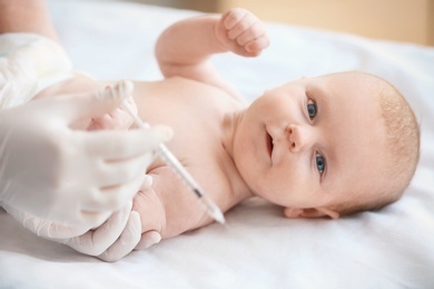 Doctor vaccinating baby in clinic