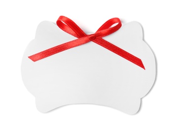 Photo of Blank gift tag with satin ribbon on white background, top view