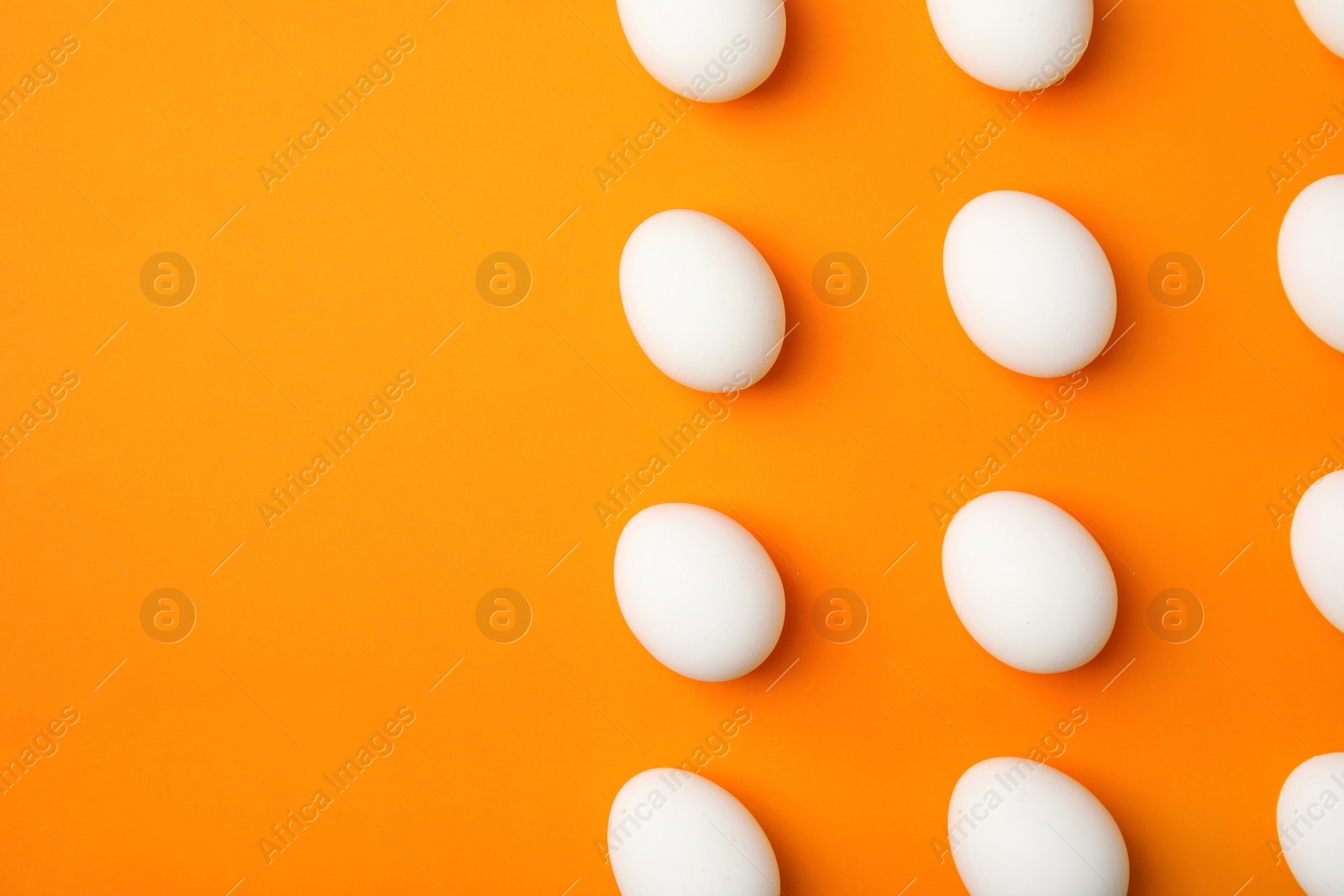 Photo of Raw chicken eggs on color background, top view. Space for text