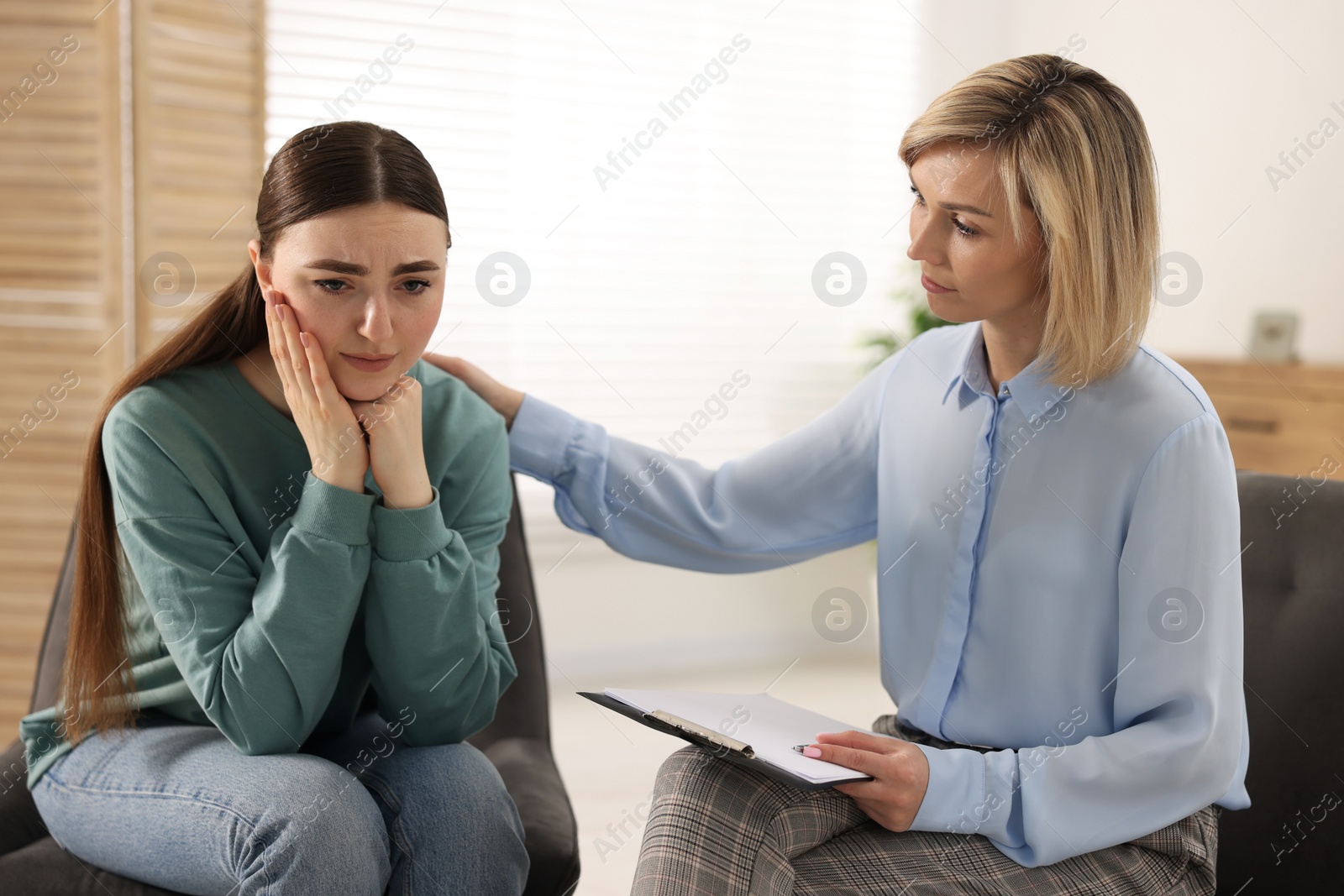 Photo of Professional psychotherapist working with patient in office