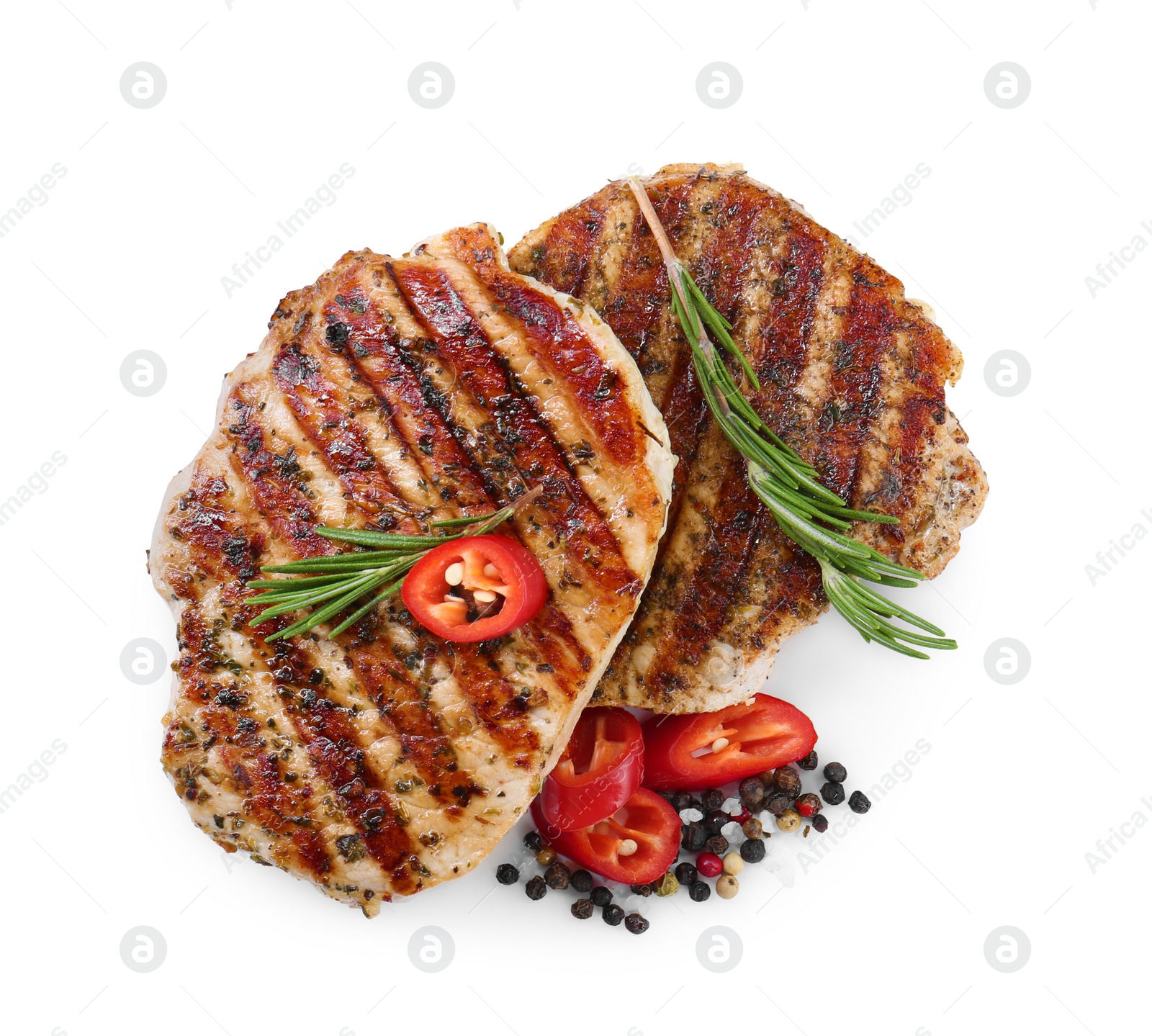 Photo of Delicious fried pork steaks, rosemary, chili pepper and peppercorns isolated on white, top view