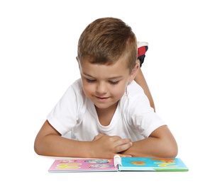 Photo of Cute little boy reading book on white background