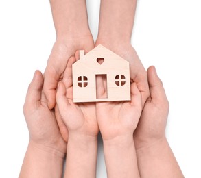 Home security concept. Family holding house model on white background, top view