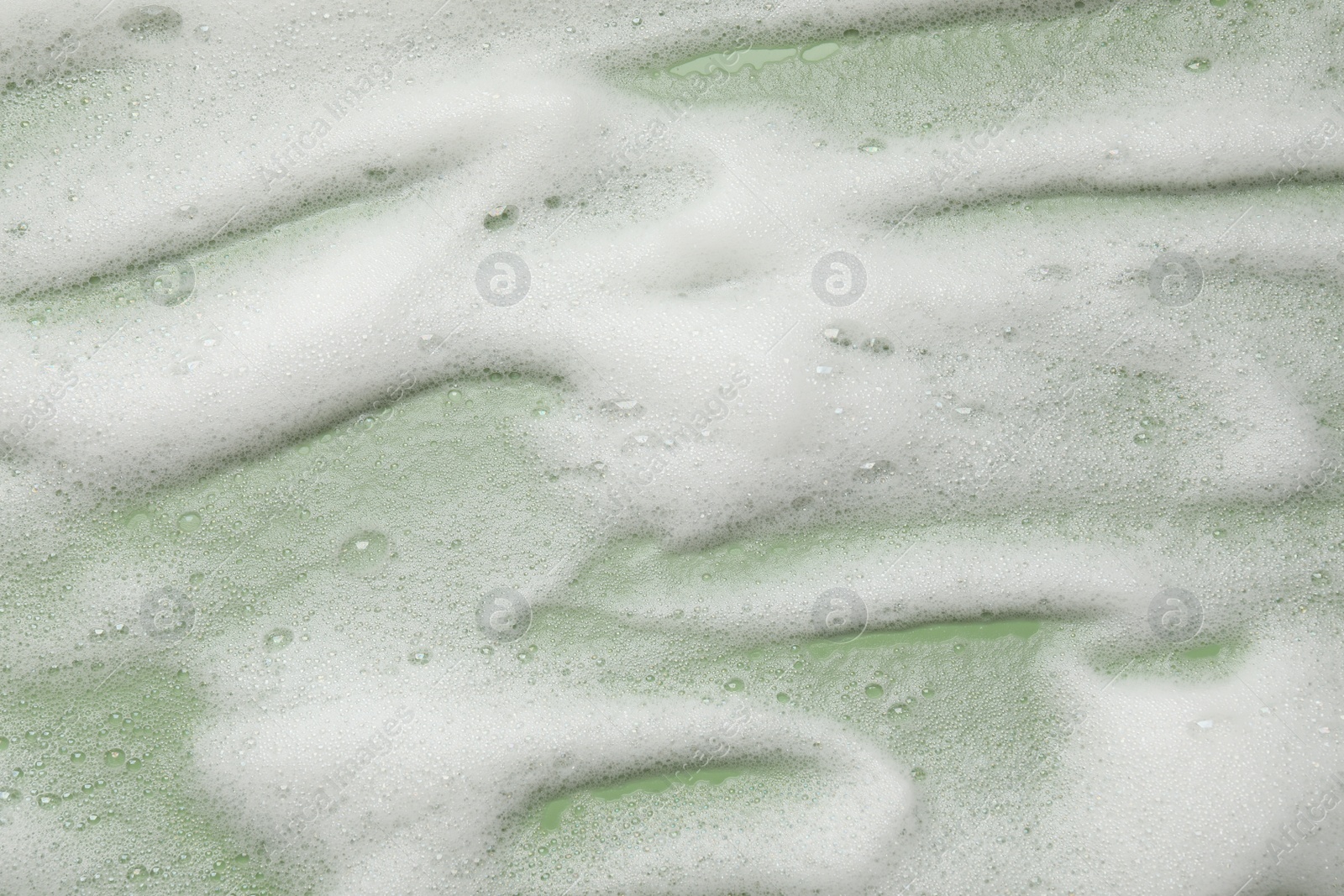 Photo of White washing foam on olive background, top view