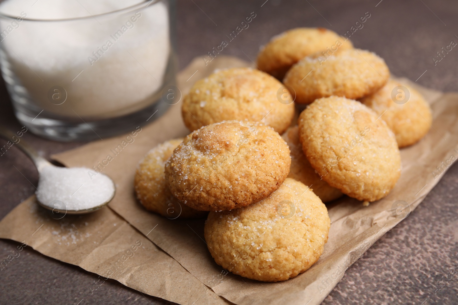 Photo of Tasty sweet sugar cookies on brown table, closeup