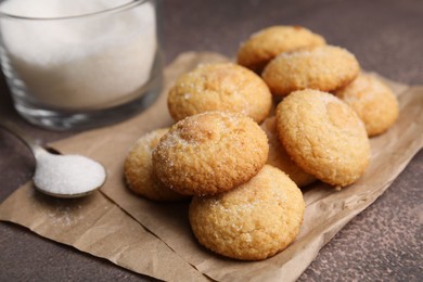 Photo of Tasty sweet sugar cookies on brown table, closeup