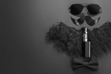 Photo of Flat lay composition with artificial moustache and sunglasses on black background, space for text