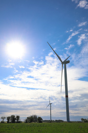 Photo of Beautiful view of field with wind turbines. Alternative energy source