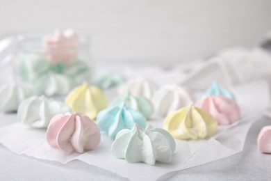 Photo of Tasty meringue cookies on light grey table, closeup