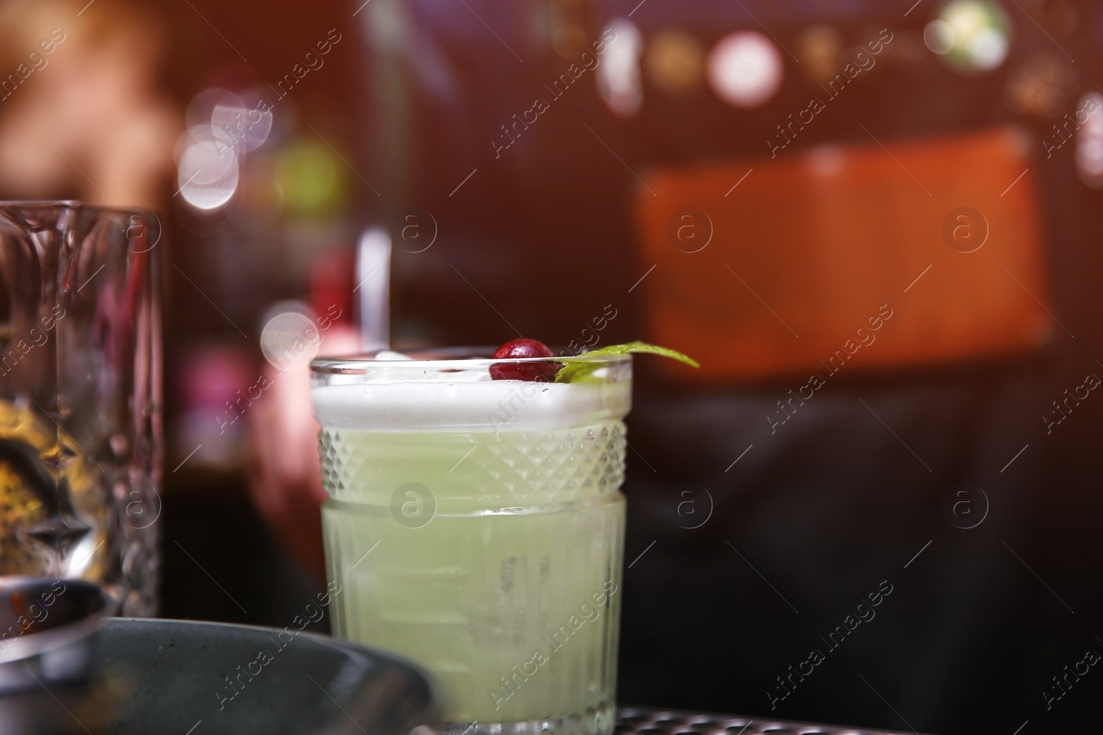 Photo of Glass of tasty cocktail on bar counter