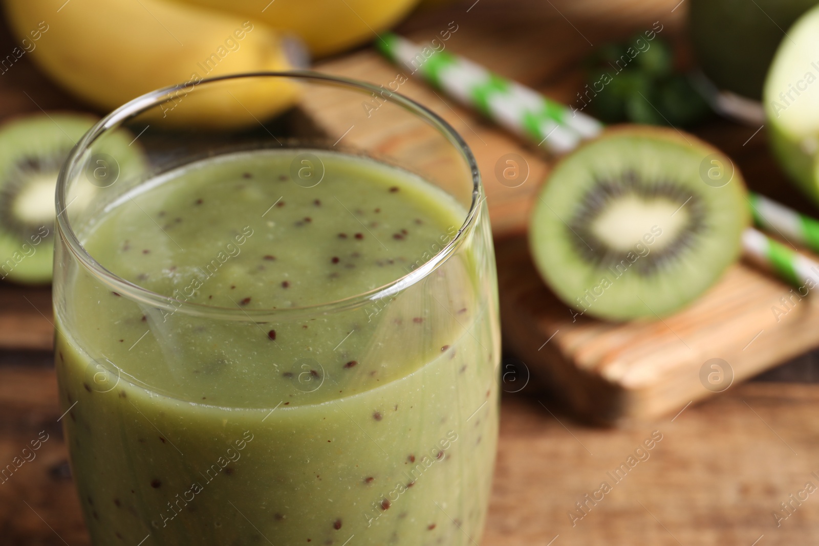 Photo of Delicious kiwi smoothie in glass, closeup view