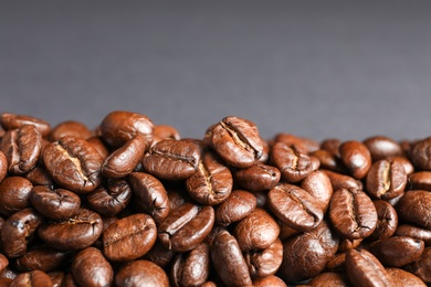 Photo of Roasted coffee beans on grey background, closeup