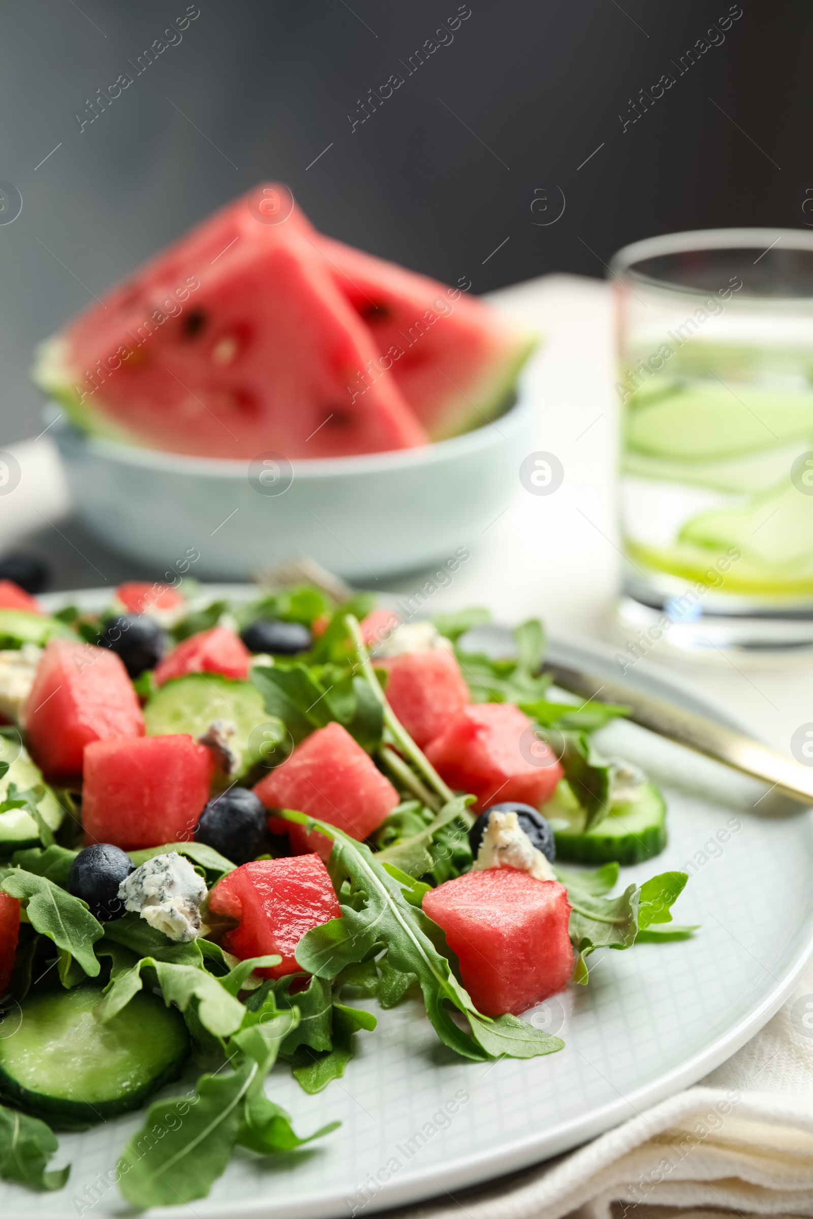 Photo of Delicious salad with watermelon served on plate, closeup