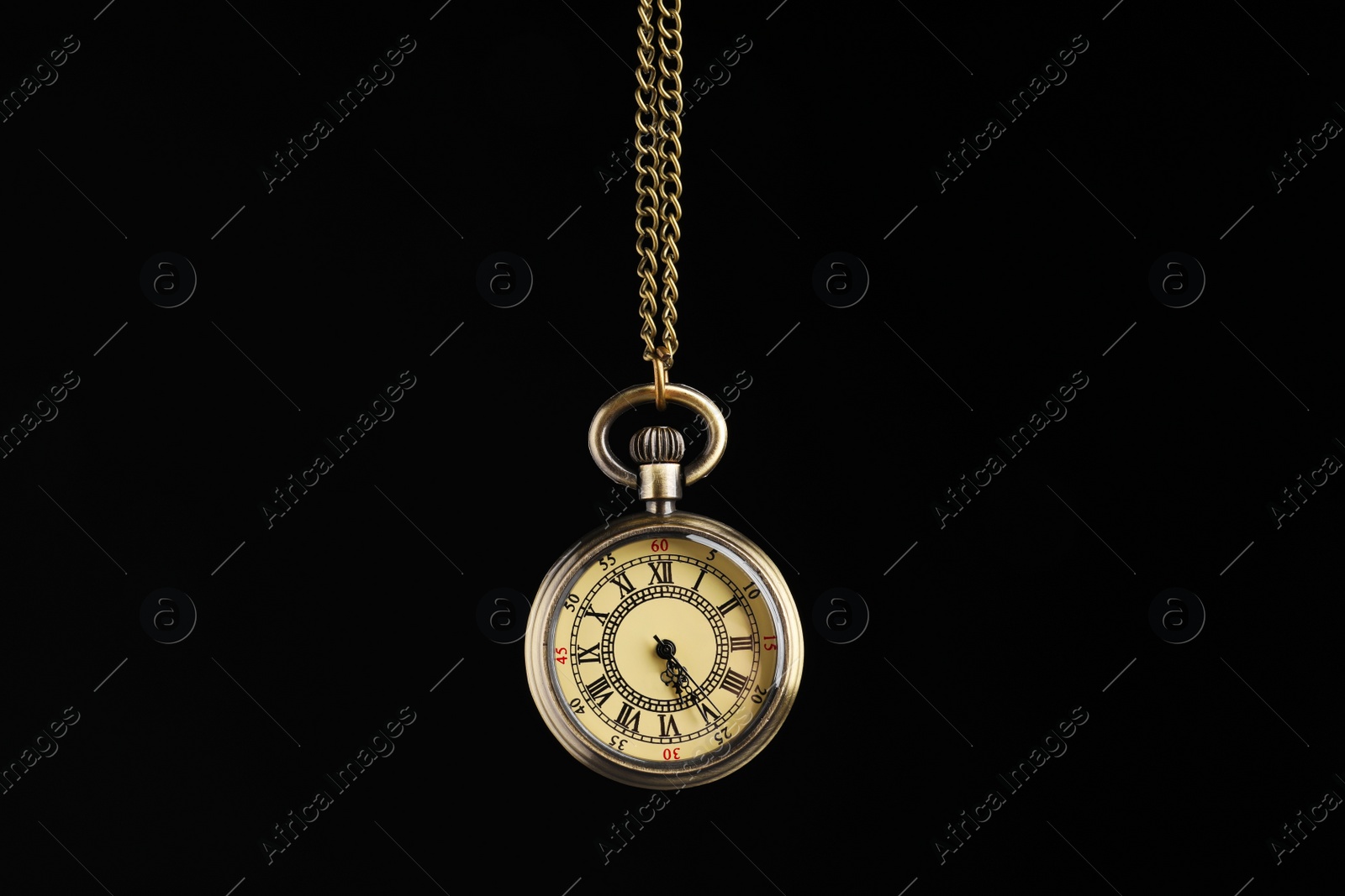 Photo of Beautiful vintage pocket watch with chain on black background. Hypnosis session