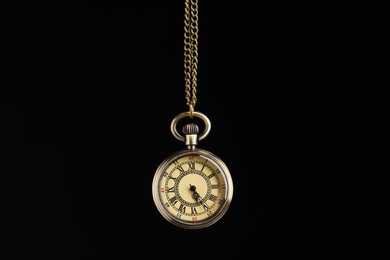 Beautiful vintage pocket watch with chain on black background. Hypnosis session