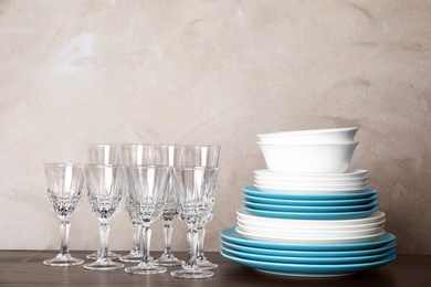 Photo of Set of dinnerware on table against grey background. Interior element