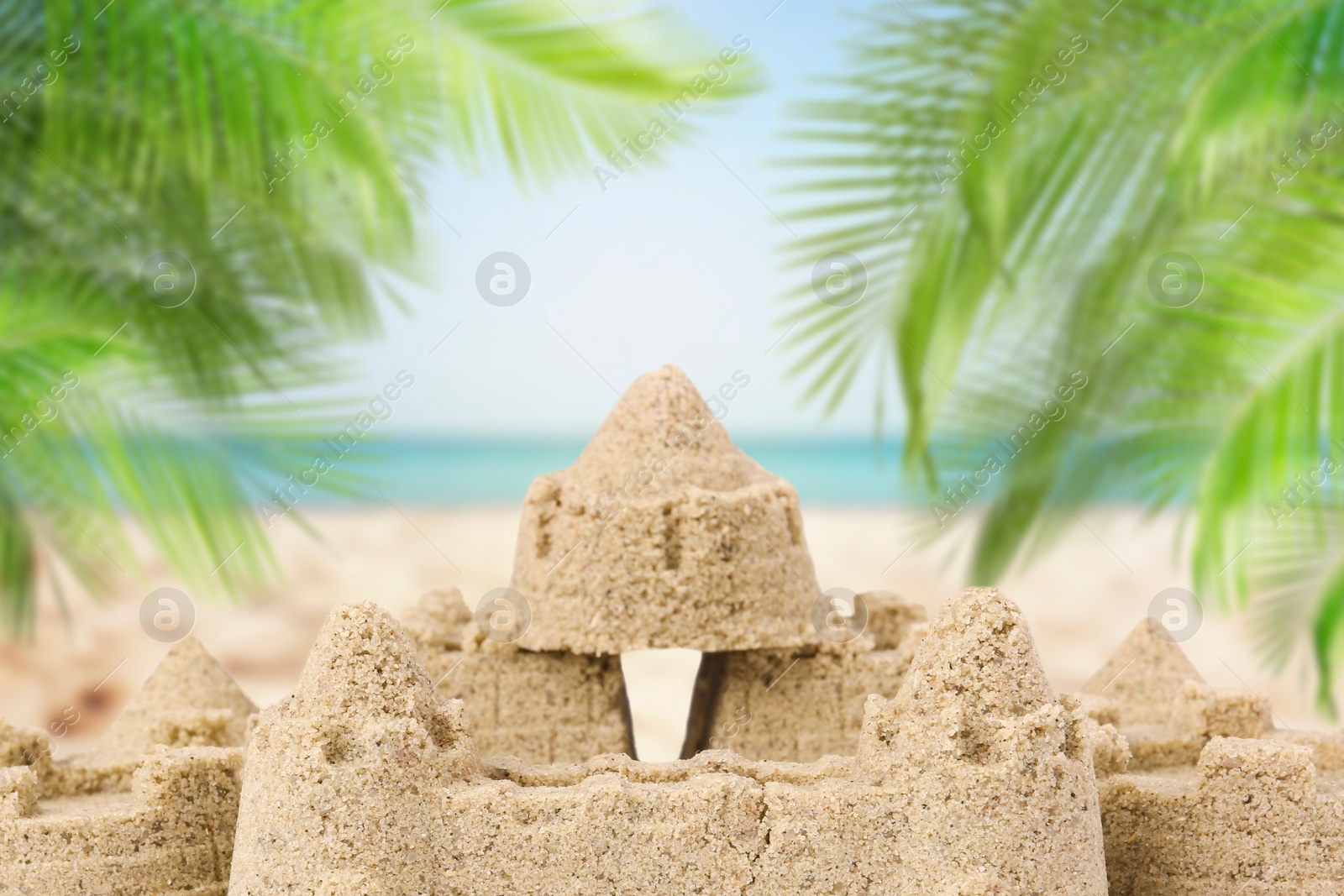 Image of Sand castle on ocean beach, closeup. Outdoor play