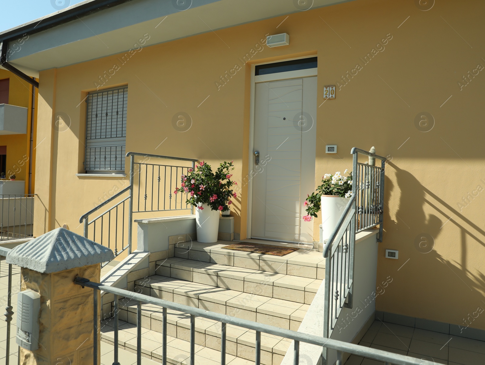 Photo of Entrance of beautiful residential building on sunny day