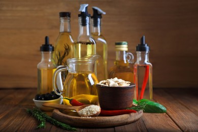 Photo of Different cooking oils and ingredients on wooden table