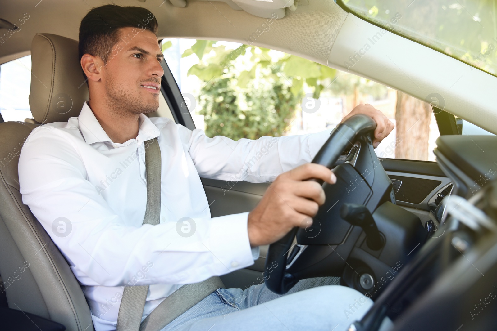 Photo of Male driver with fastened safety belt in car