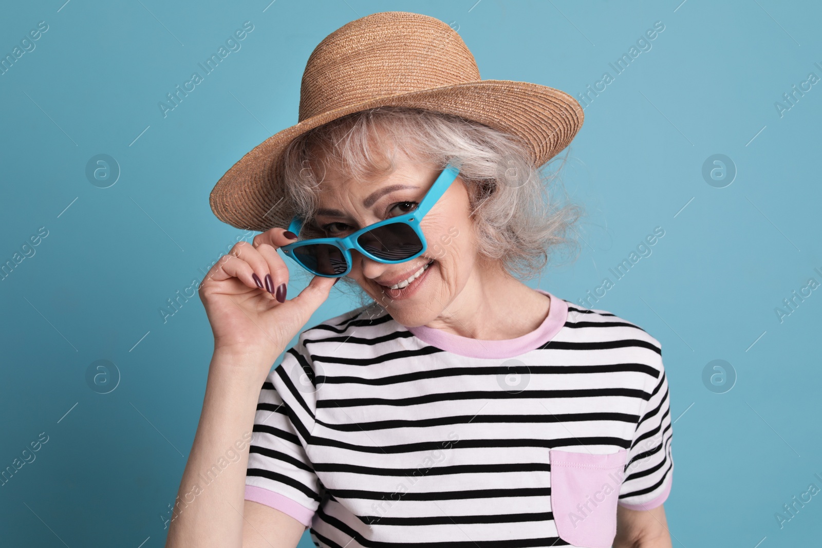 Photo of Portrait of mature woman in hipster outfit on color background