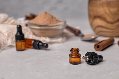 Closeup of bottle with cinnamon oil on light table